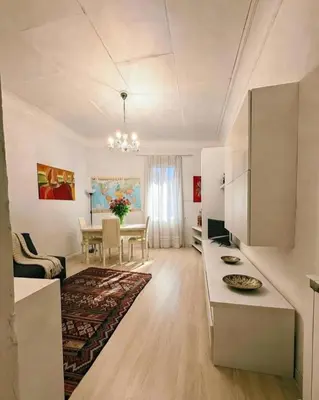 a living room with a kitchen and a dining room at Gorgeous Flat In Pigneto in Rome