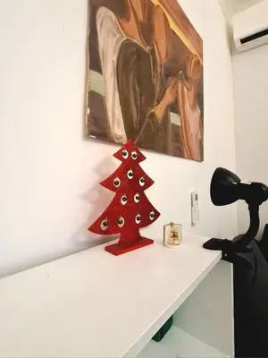 a red christmas tree sitting on top of a white table at Gorgeous Flat In Pigneto in Rome