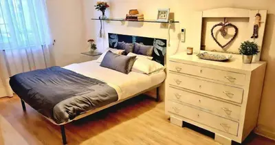 a bedroom with a large bed and a dresser at Gorgeous Flat In Pigneto in Rome