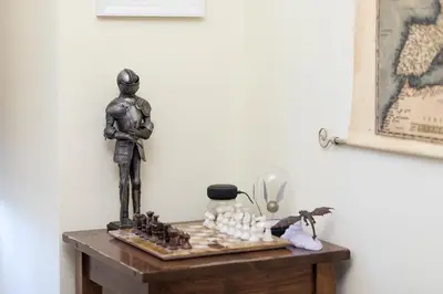 a statue of a man playing chess on a table at Da Alessia Per Dormire Al Coppedé in Rome