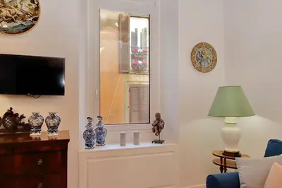 a living room with a window and vases on a shelf at Luxury apartment in Rione Monti in Rome