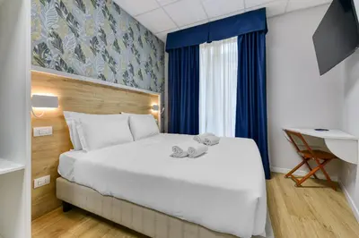 a hotel room with a bed with two teddy bears on it at ROME'S GLORIA HOTEL in Rome