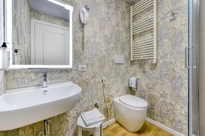 a bathroom with a sink and a toilet at ROME'S GLORIA HOTEL in Rome