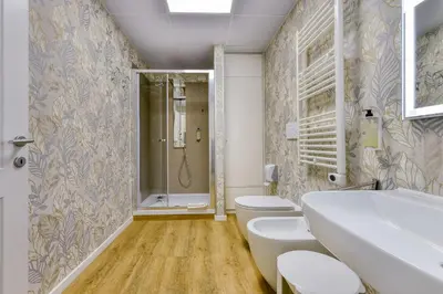 a bathroom with a shower and a toilet and a sink at ROME'S GLORIA HOTEL in Rome