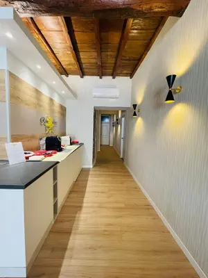 an office corridor with white walls and a wooden ceiling at ROME'S GLORIA HOTEL in Rome