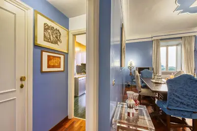 a dining room with blue walls and a table at Vespasiano Luxury apartment for 4 in Rome