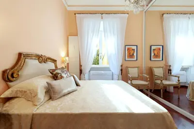 a bedroom with a large bed with a mirror at Vespasiano Luxury apartment for 4 in Rome
