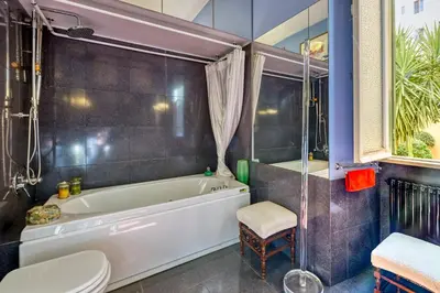 a bathroom with a tub and a toilet and a sink at Vespasiano Luxury apartment for 4 in Rome