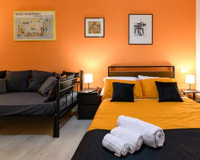 a bedroom with two beds and a couch at Rainbow Vatican home in Rome
