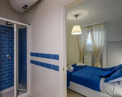 a bathroom with a bed and a shower at Rainbow Vatican home in Rome