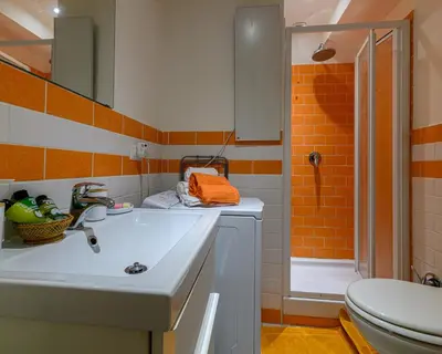 a bathroom with a sink and a shower at Rainbow Vatican home in Rome