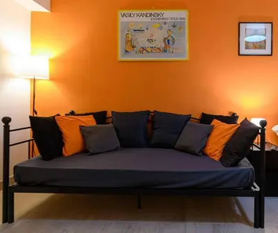 a couch with colorful pillows sitting in a room at Rainbow Vatican home in Rome