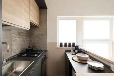 a kitchen with a sink and a stove top oven at Japandi Space by Nosdom Properties in Rome