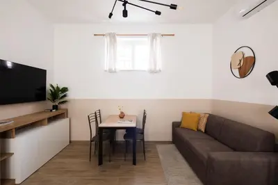 a living room with a couch and a table at Japandi Space by Nosdom Properties in Rome