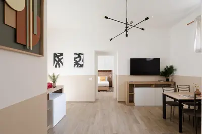 a living room with a dining table and a television at Japandi Space by Nosdom Properties in Rome