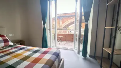 a bedroom with a bed and a window with a view at Ele rooms San Pietro in Rome