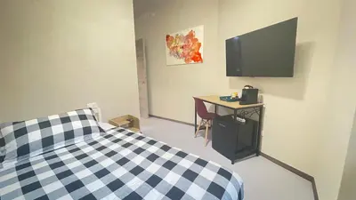 a bedroom with a bed and a desk and a television at Ele rooms San Pietro in Rome
