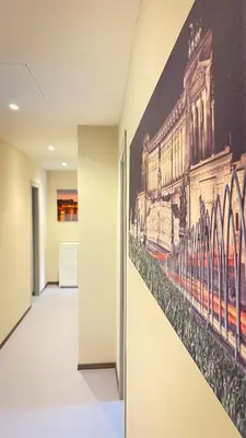 a hallway with a painting of a train on the wall at Ele rooms San Pietro in Rome