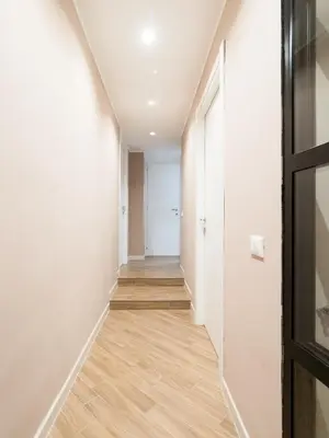 an empty hallway with white walls and wood floors at Casa TPZ Metro Baldo - Close To Vatican in Rome