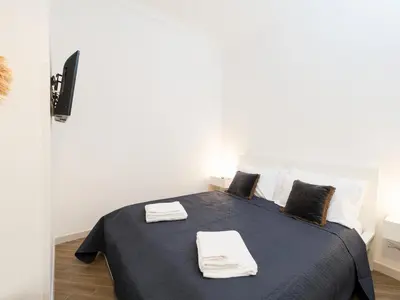 a bedroom with a bed with two towels on it at Casa TPZ Metro Baldo - Close To Vatican in Rome