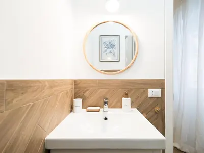 a bathroom with a white sink and a mirror at Casa TPZ Metro Baldo - Close To Vatican in Rome