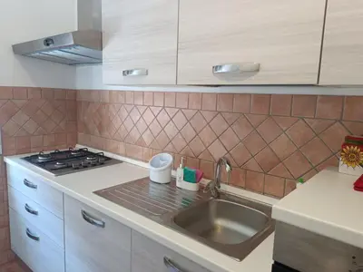 a kitchen with a sink and a stove at Beauty apartment in the green, direct link with center in Rome