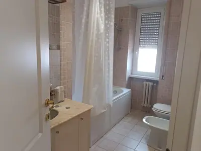 a bathroom with a tub and a toilet and a sink at Beauty apartment in the green, direct link with center in Rome