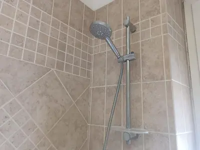 a shower with a shower head in a bathroom at Beauty apartment in the green, direct link with center in Rome
