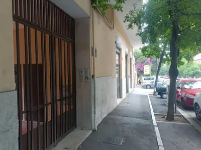 a building with a gate on the side of a street at Beauty apartment in the green, direct link with center in Rome