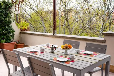 a table with a bowl of fruit on a patio at Lungotevere Testaccio Rooftop in Rome