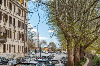 a street with cars parked on the side of the road at Lungotevere Testaccio Rooftop in Rome