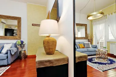 a living room with a lamp on a table at St Peter 1- Pretty Cozy Apartment (50m from metro) in Rome