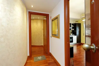 a hallway with a door leading to a kitchen at St Peter 1- Pretty Cozy Apartment (50m from metro) in Rome