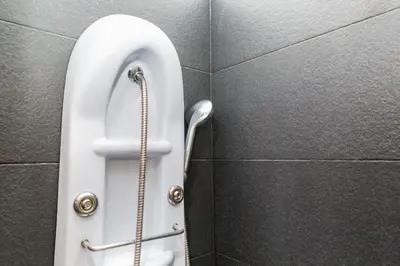 a urinal in a bathroom with a hose at S. Peter 2 - Apartment with garden -50m from metro in Rome