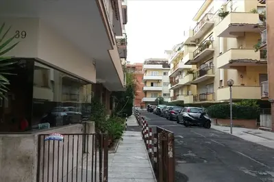 a street with cars parked on the side of a building at St. Peter - Loft at 50m from Metro (up to 4) in Rome