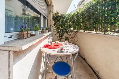 a table and chairs on a balcony with plants at St. Peter - Loft at 50m from Metro (up to 4) in Rome