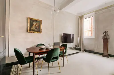 a dining room with a table and green chairs at Luxury apartment in Trastevere in Rome