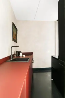 a kitchen with an orange counter and a sink at Luxury apartment in Trastevere in Rome