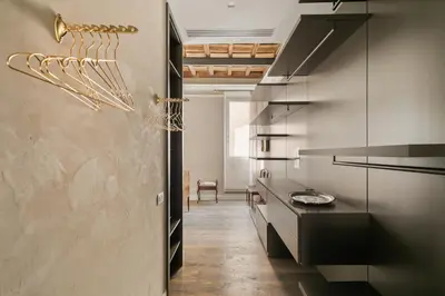 a kitchen with stainless steel cabinets and a hallway at Luxury apartment in Trastevere in Rome