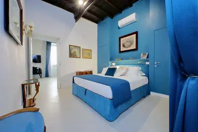 a blue bedroom with a bed and a blue wall at A 2 passi da Piazza di Spagna in Rome