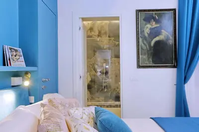 a living room with a white couch and a mirror at A 2 passi da Piazza di Spagna in Rome