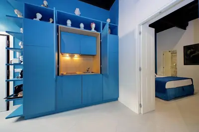 a blue room with a window and a blue wall at A 2 passi da Piazza di Spagna in Rome
