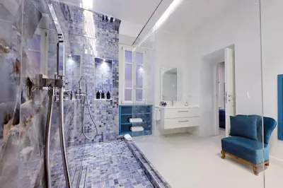 a bathroom with a shower and a blue chair at A 2 passi da Piazza di Spagna in Rome