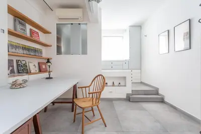 a kitchen with a white counter and a wooden chair at Flaminio Historic Charm and Modern Flair in Rome