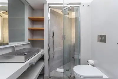 a bathroom with a shower and a toilet and a sink at Flaminio Historic Charm and Modern Flair in Rome