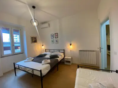 a bedroom with two beds and a couch at Casa Arcangela by GHOR in Rome