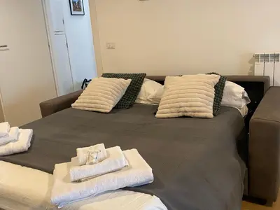 a bed with towels sitting on top of it at Casa Arcangela by GHOR in Rome