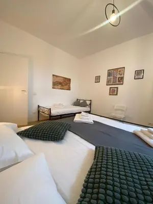 a room with two beds and two beds sidx sidx sidx at Casa Arcangela by GHOR in Rome