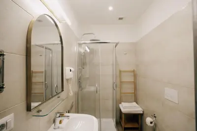 a bathroom with a shower and a sink and a mirror at Casa Mirabilia in Rome