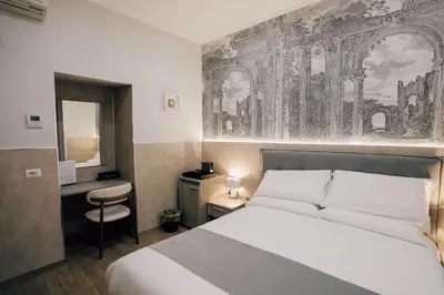 a hotel room with a bed and a desk and a bedroom at Casa Mirabilia in Rome